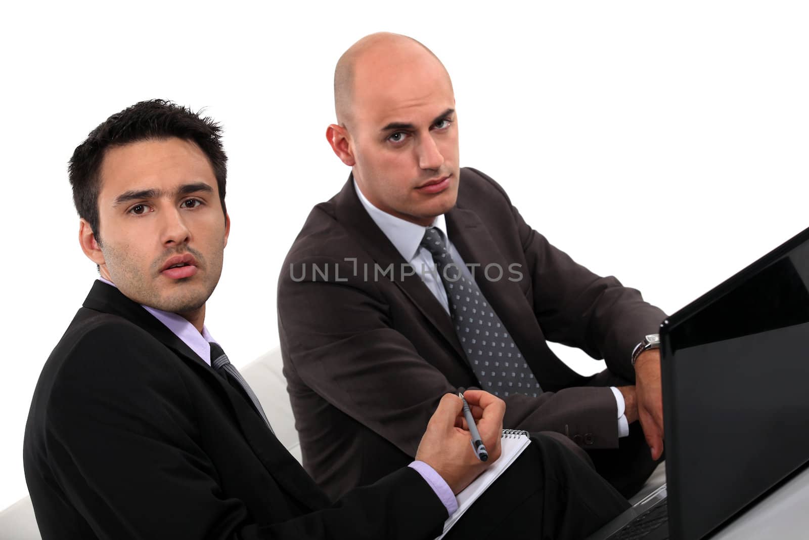 Businessmen looking at a laptop