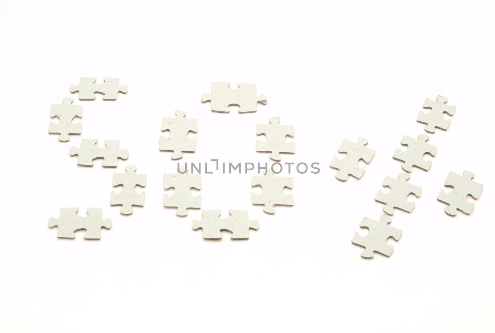 Puzzle pieces on a white background. Fifty percent      