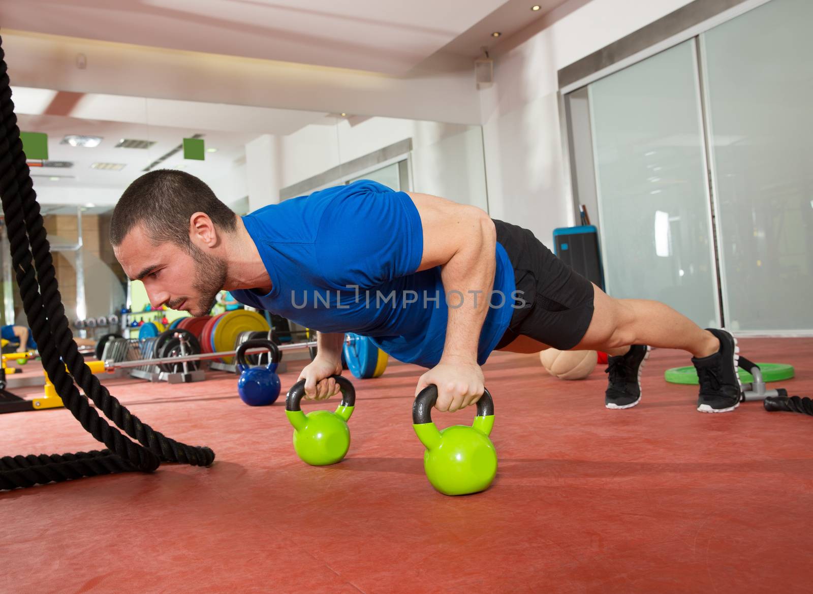 Crossfit fitness man push ups Kettlebells pushup exercise by lunamarina