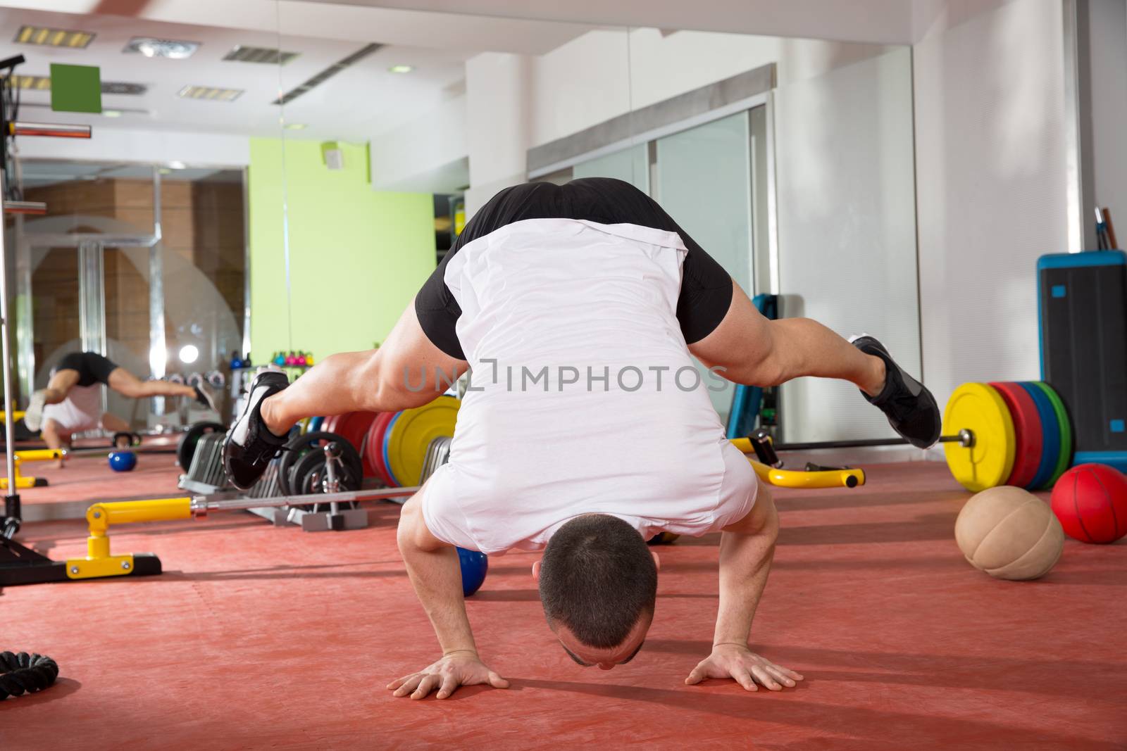 Crossfit fitness handstand push ups balance man workout at gym
