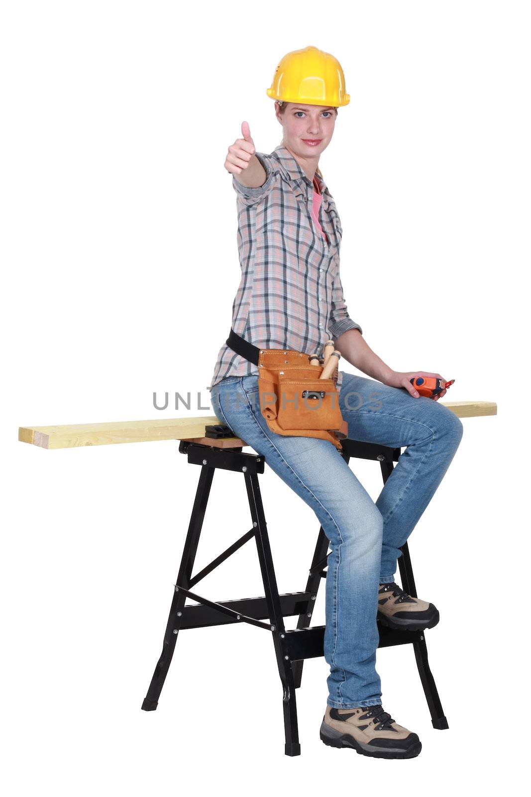 Thumbs up from a female carpenter