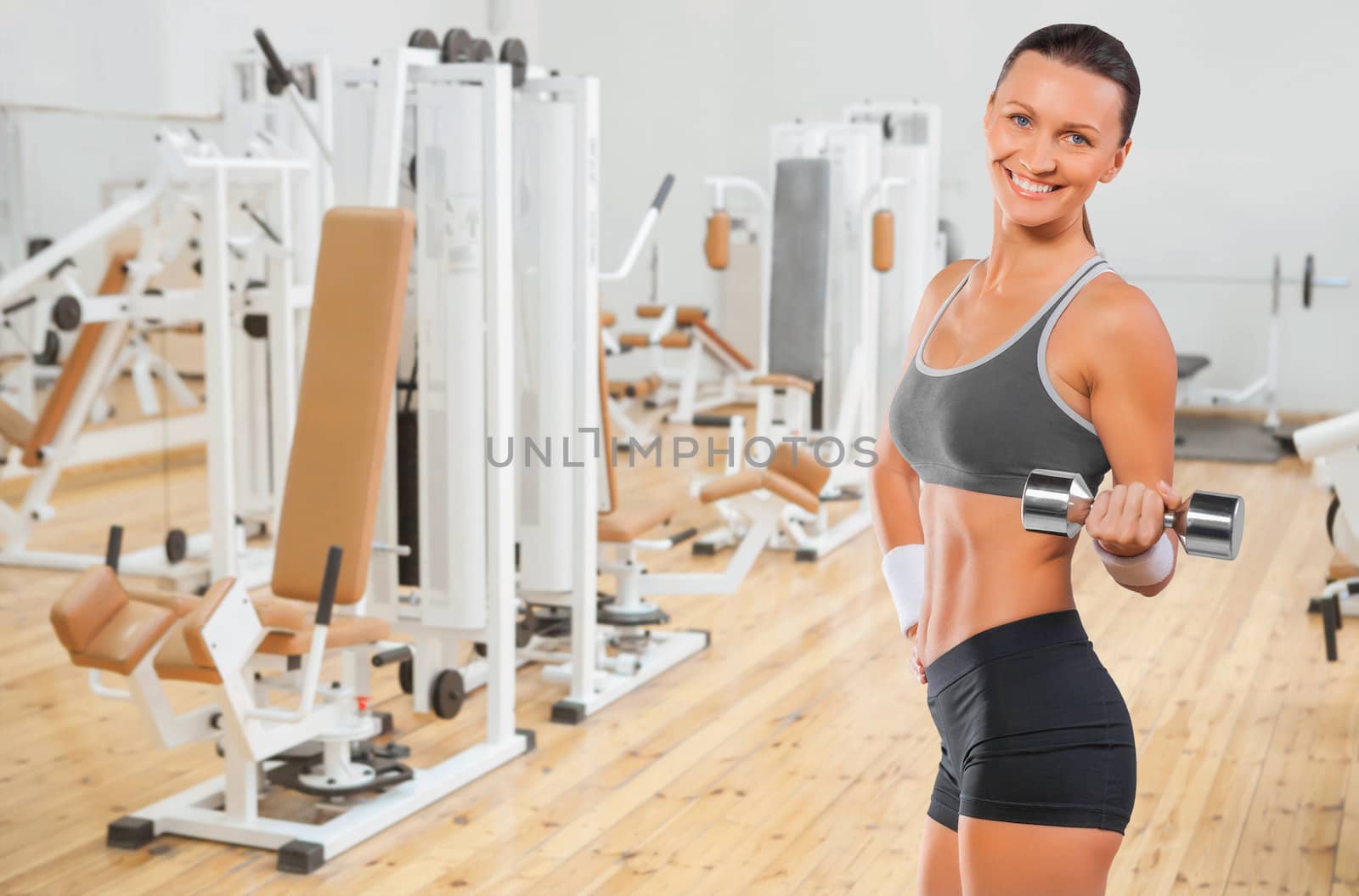 a sports female lifting weights in gym