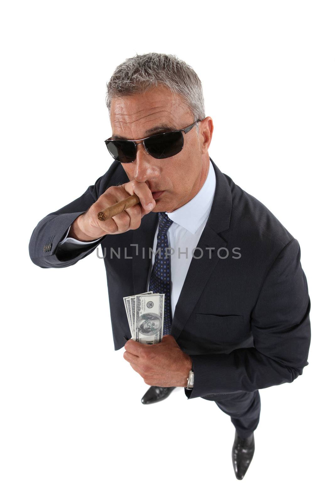 A crook holding stolen money and smoking a cigar by phovoir