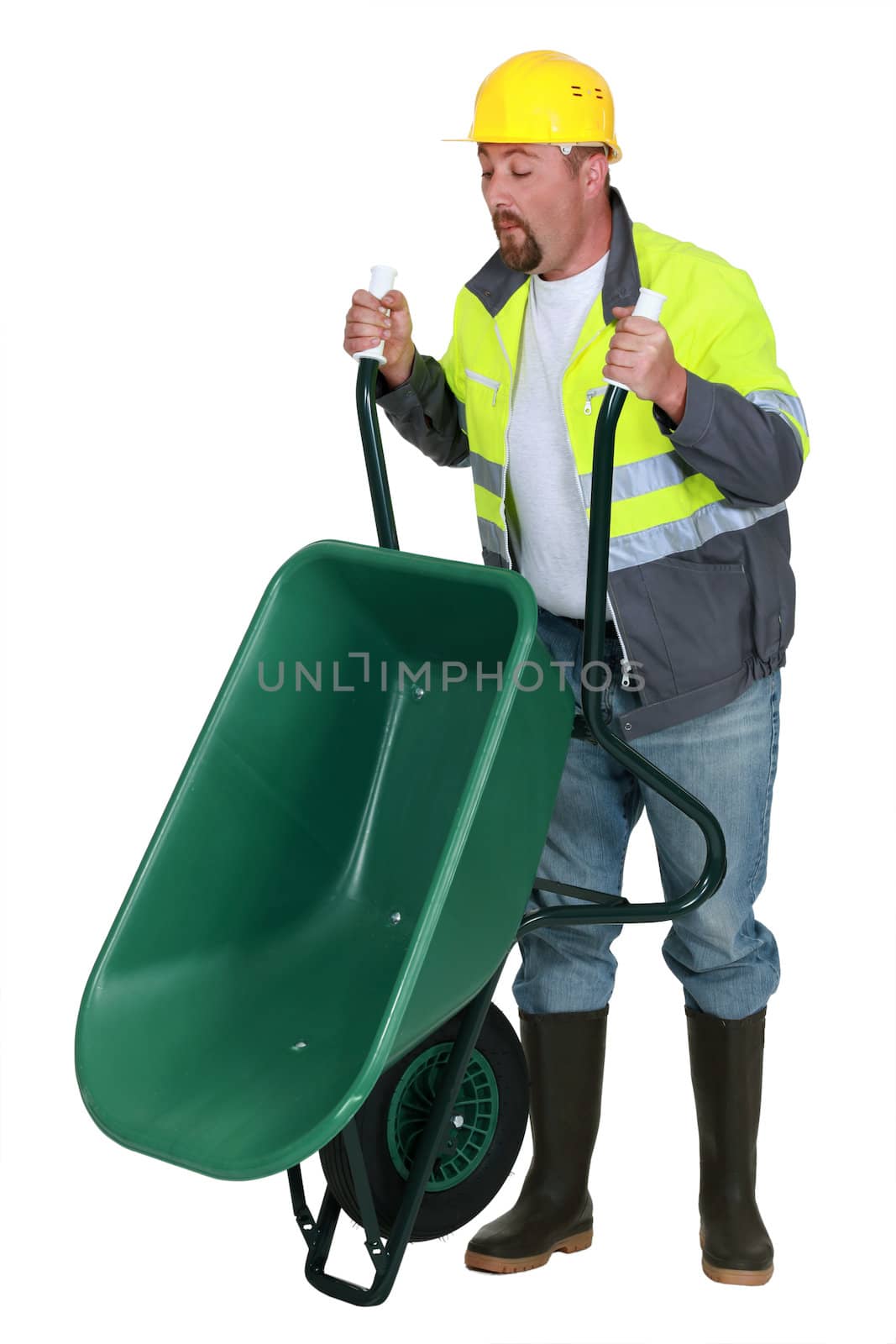 Man lifting a wheelbarrow by phovoir
