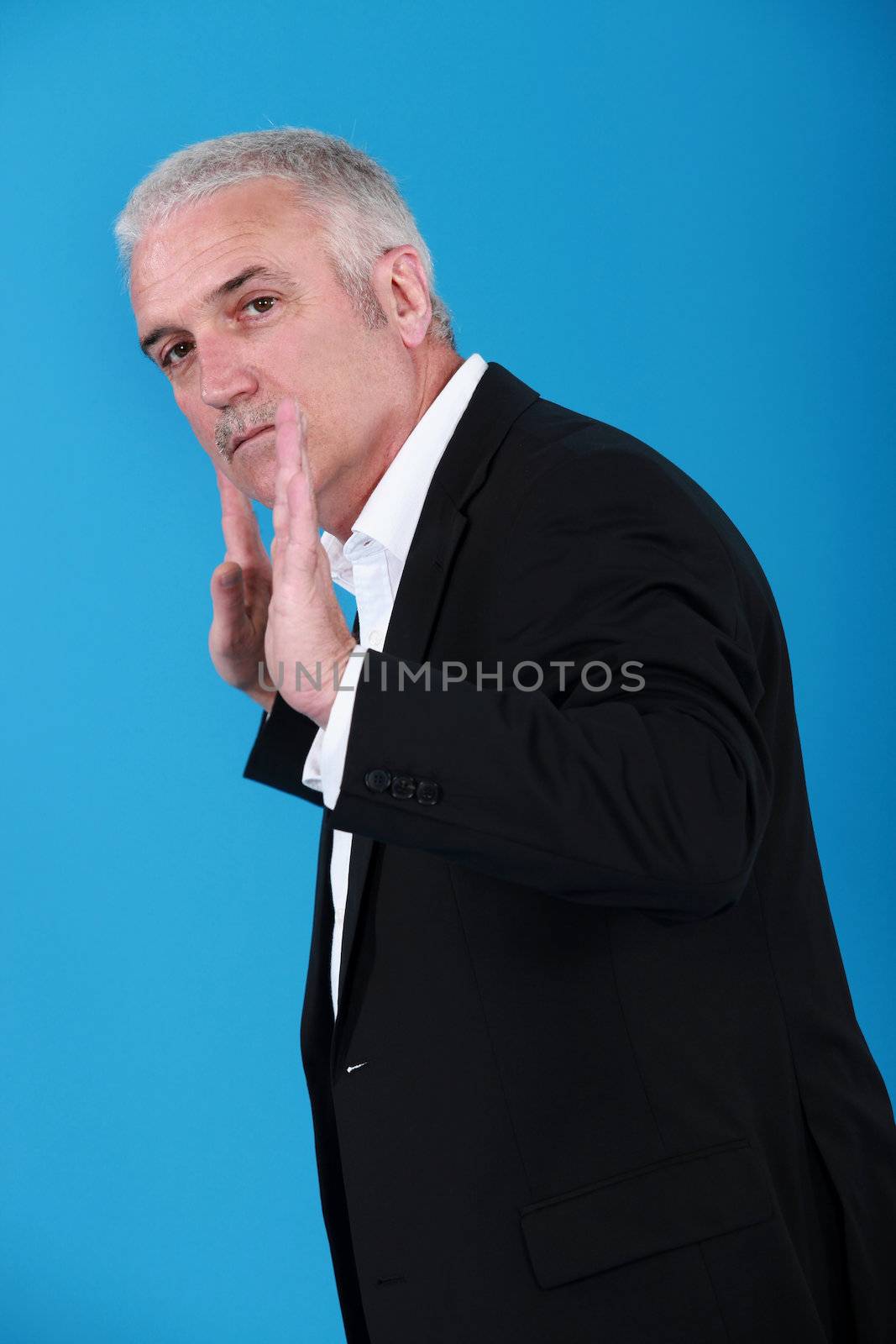 Businessman with his hands up by phovoir