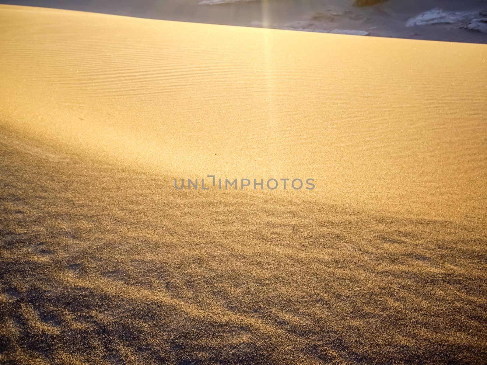 Last rays of sunlight on Death Valley Dunes by emattil