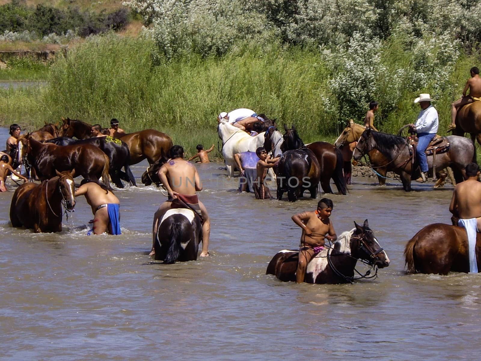 Indian warriors cool off in rivee after the reenactment of the battle