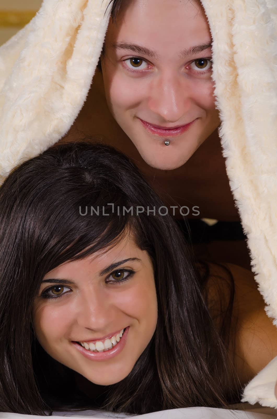 Couple under blanket by hemeroskopion
