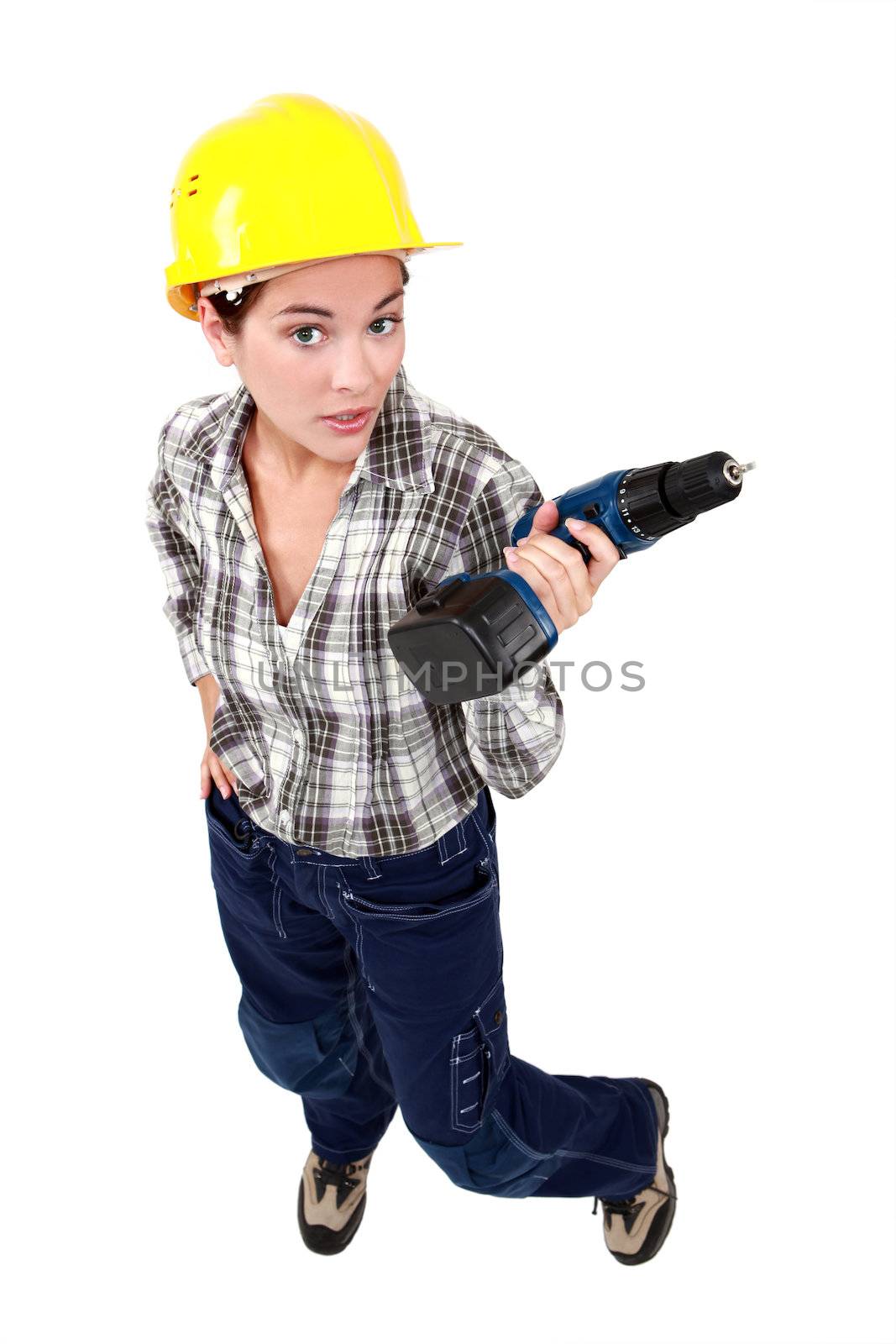 Tradeswoman holding a battery-powered power tool by phovoir
