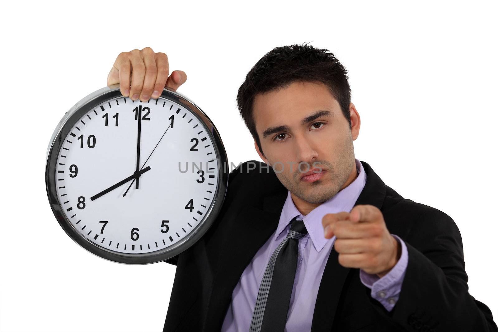 young businessman holding a clock by phovoir