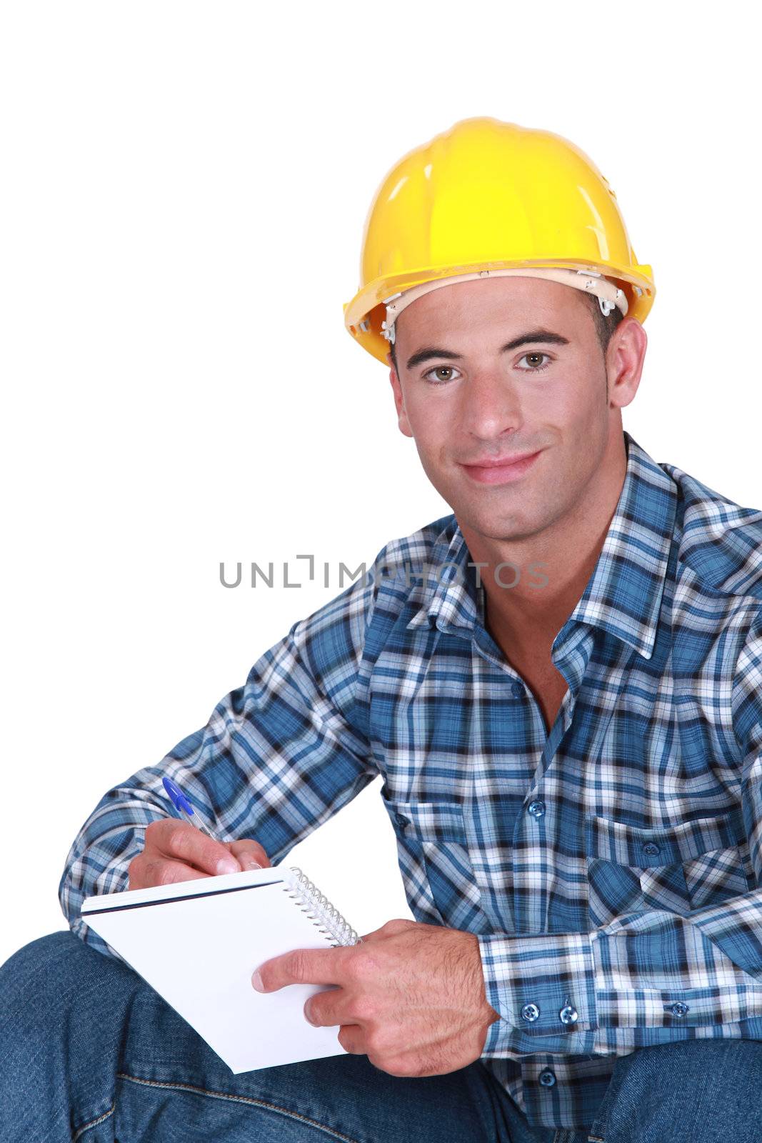 Worker writing in notebook by phovoir