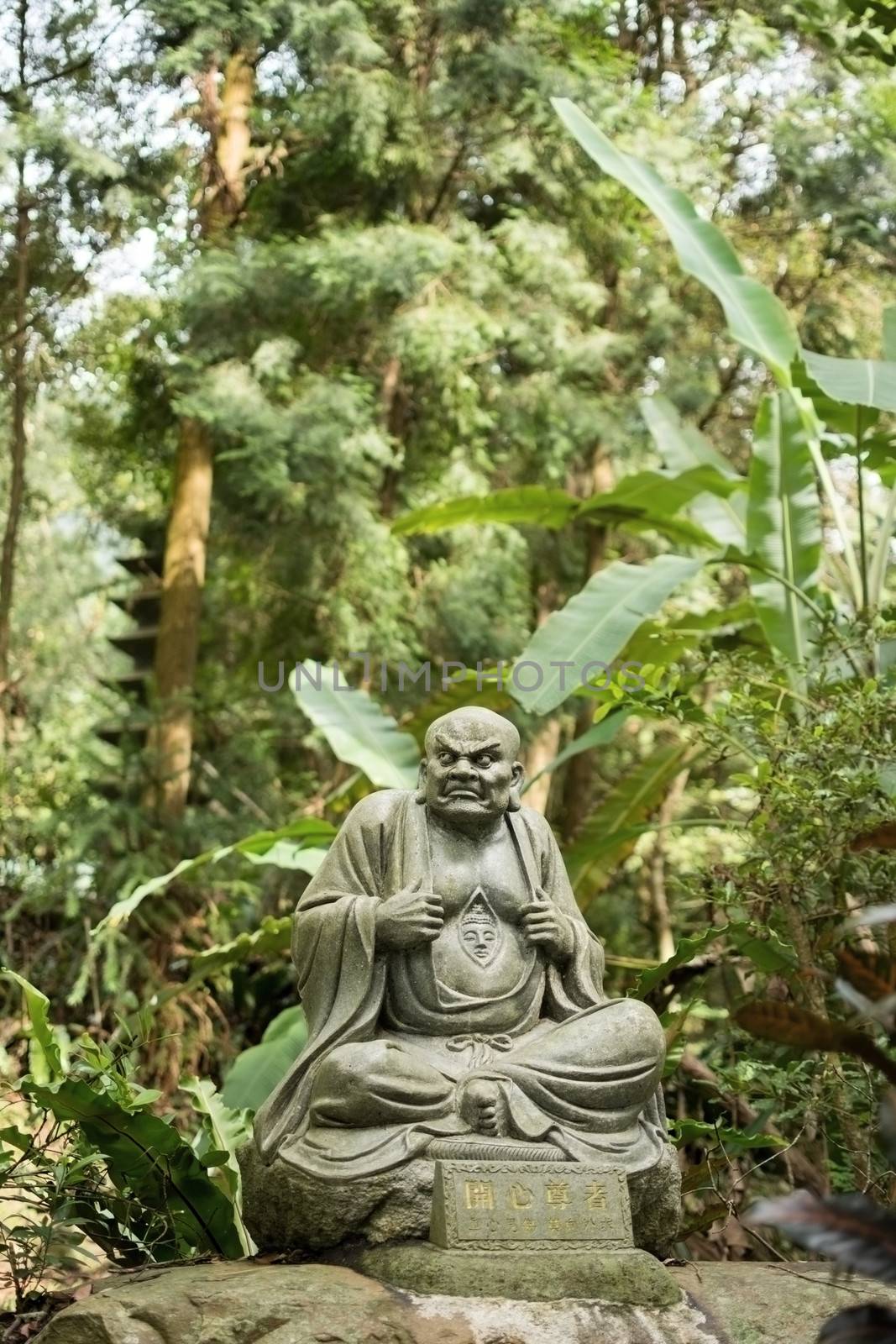 Old ruined Arhat Kanakbharadvaja statue in forest, Taiwan, Asia.