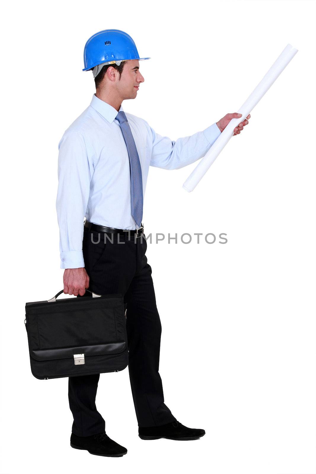 Architect with briefcase and plans by phovoir