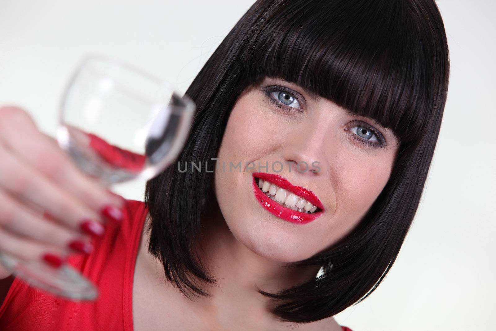 Striking woman holding a glass of water
