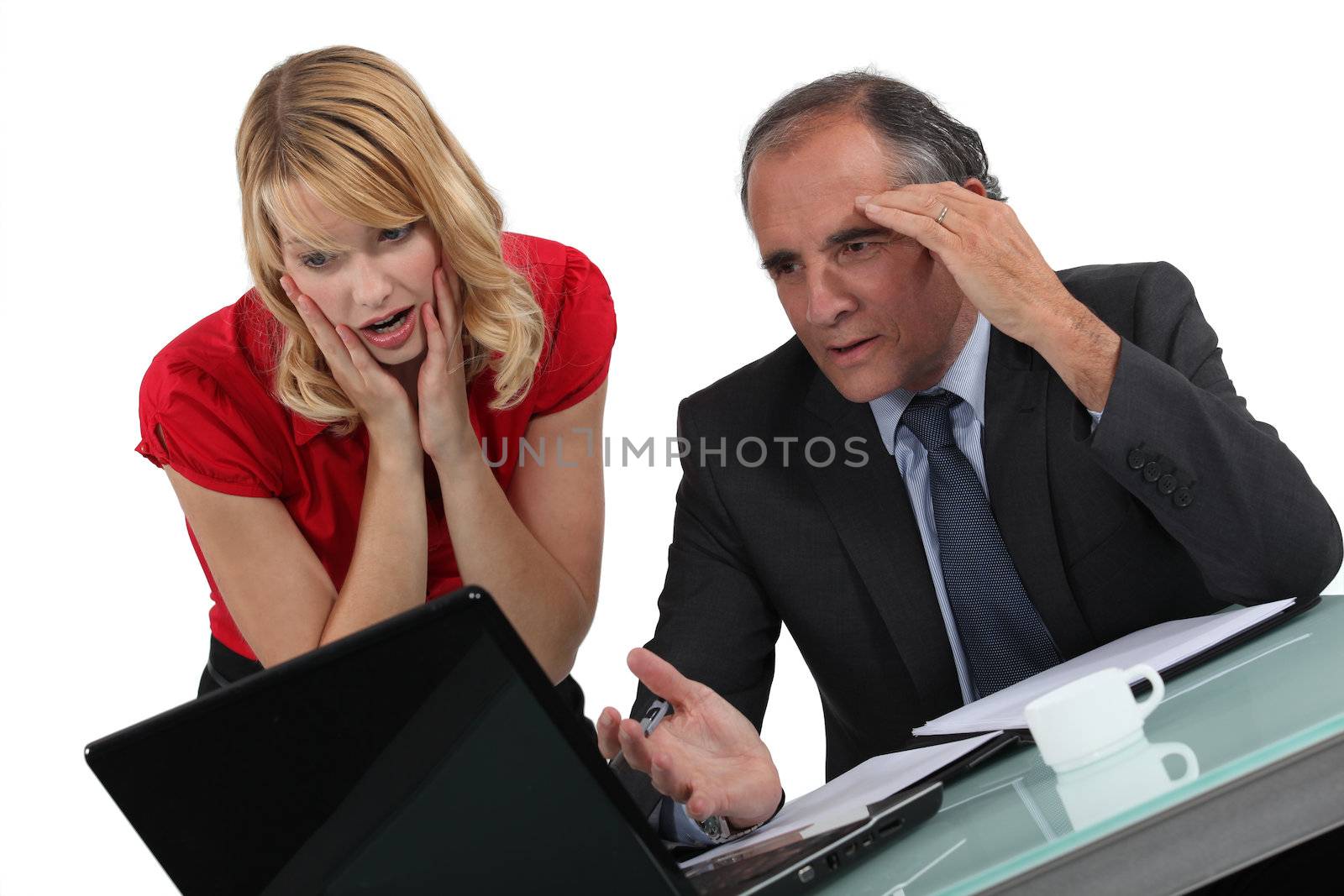 Businessman and woman facing a problem by phovoir