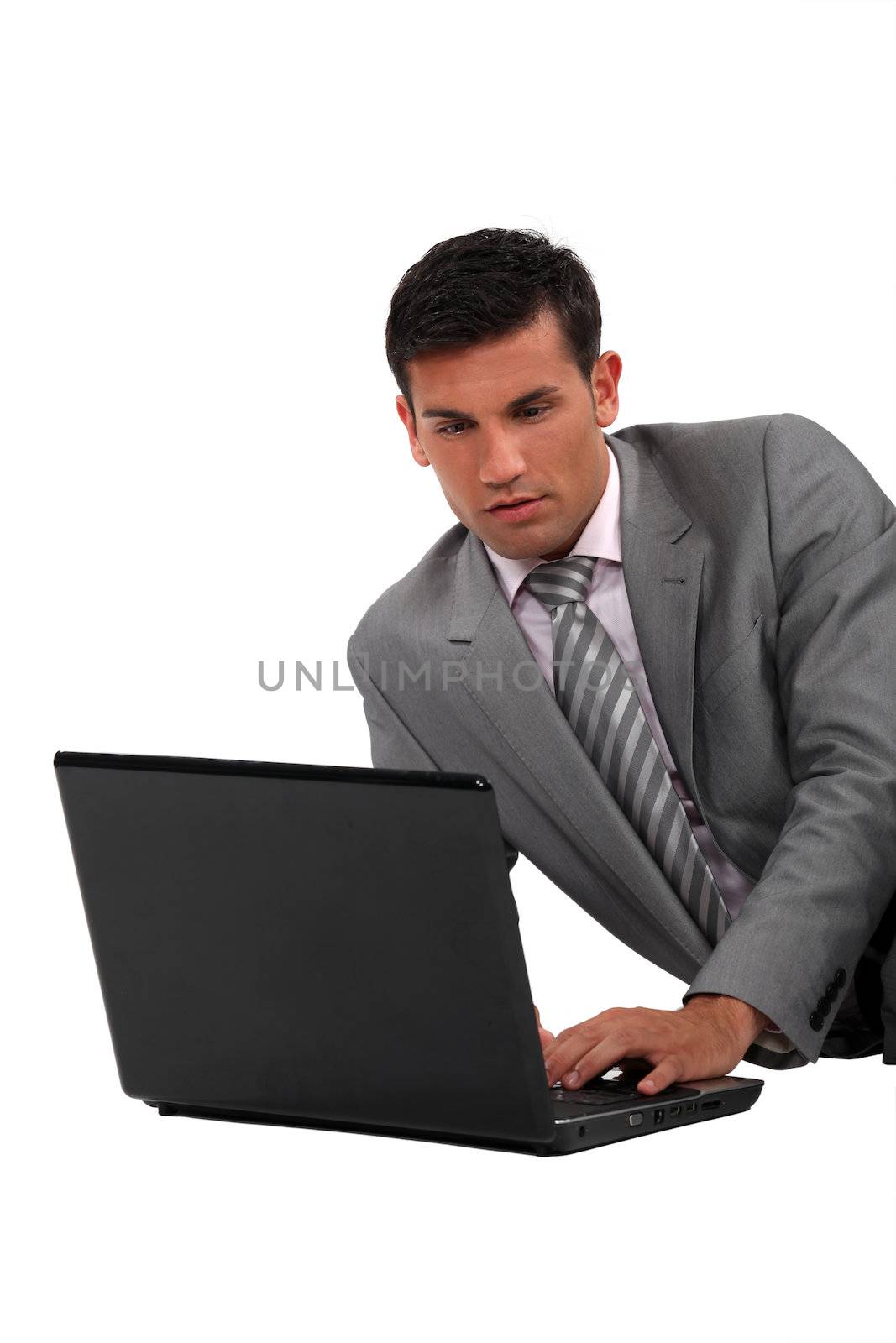 Elegant man with a computer by phovoir