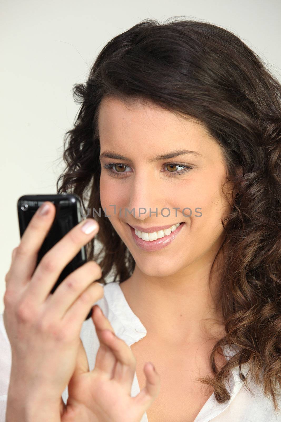 Woman with mobile phone by phovoir
