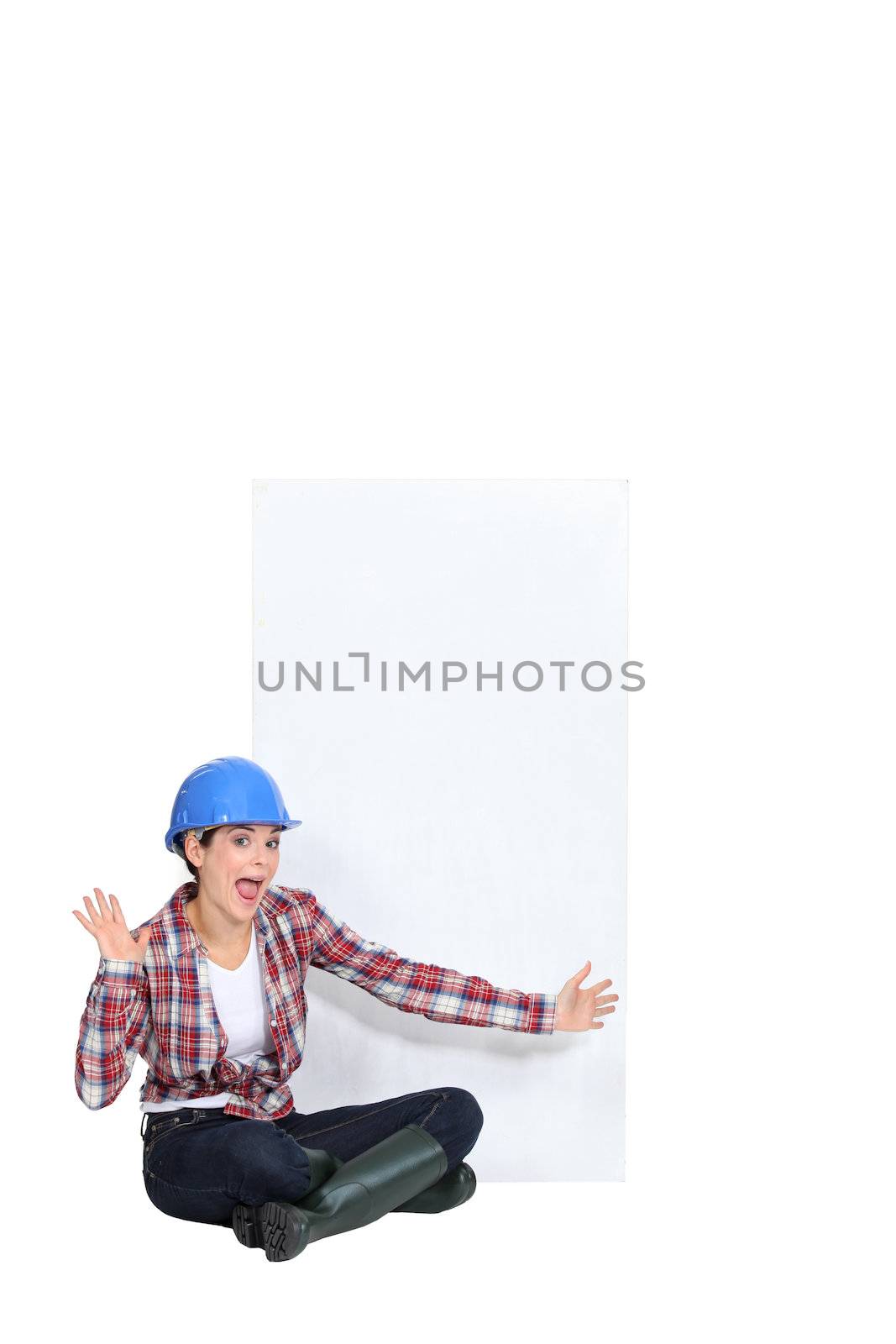 Expressive female construction worker with a blank board by phovoir