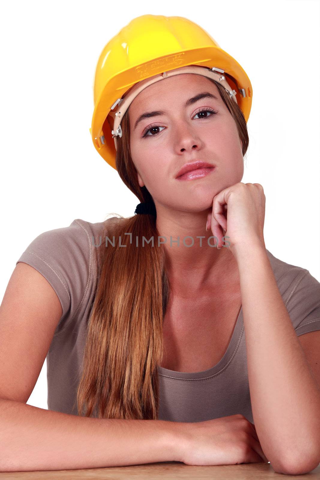 A pensive female manual worker.