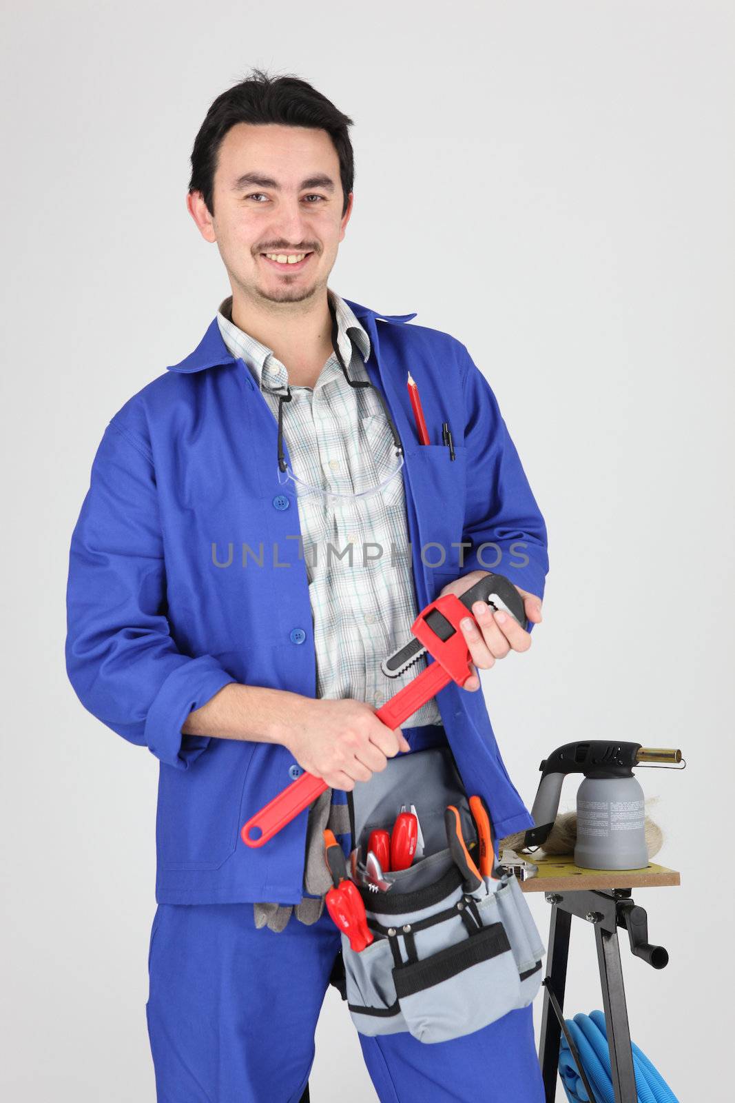 Man stood with wrench and blow torch by phovoir