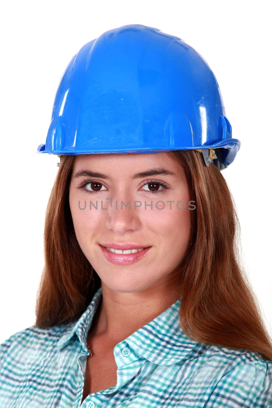 Closeup of a woman in a hardhat by phovoir