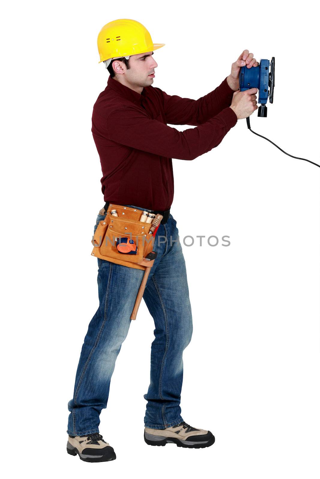 Man with an electric sander by phovoir