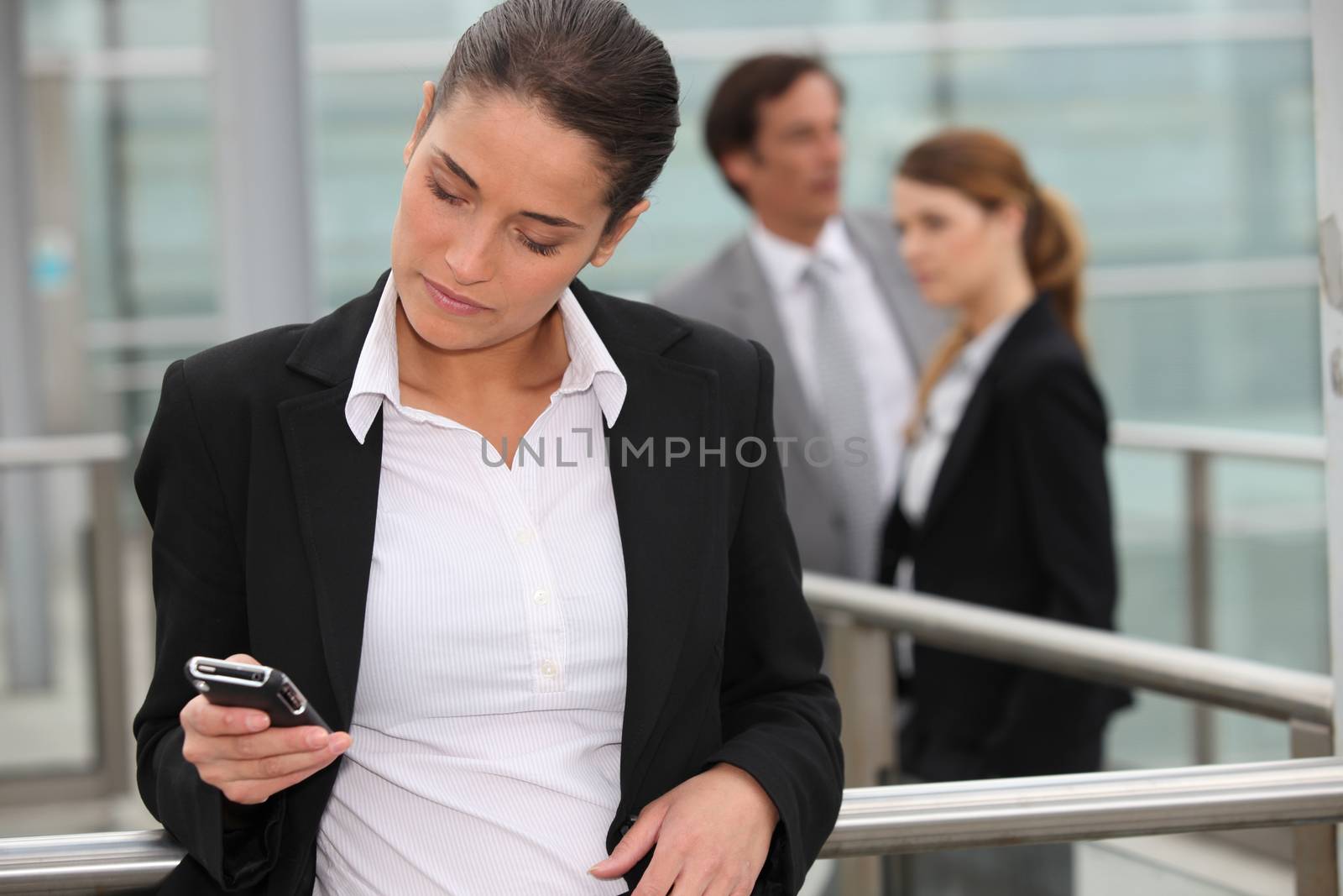 Woman reading message on mobile by phovoir