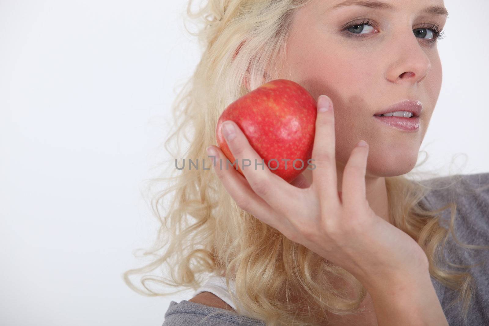 Young woman holding an apple by phovoir