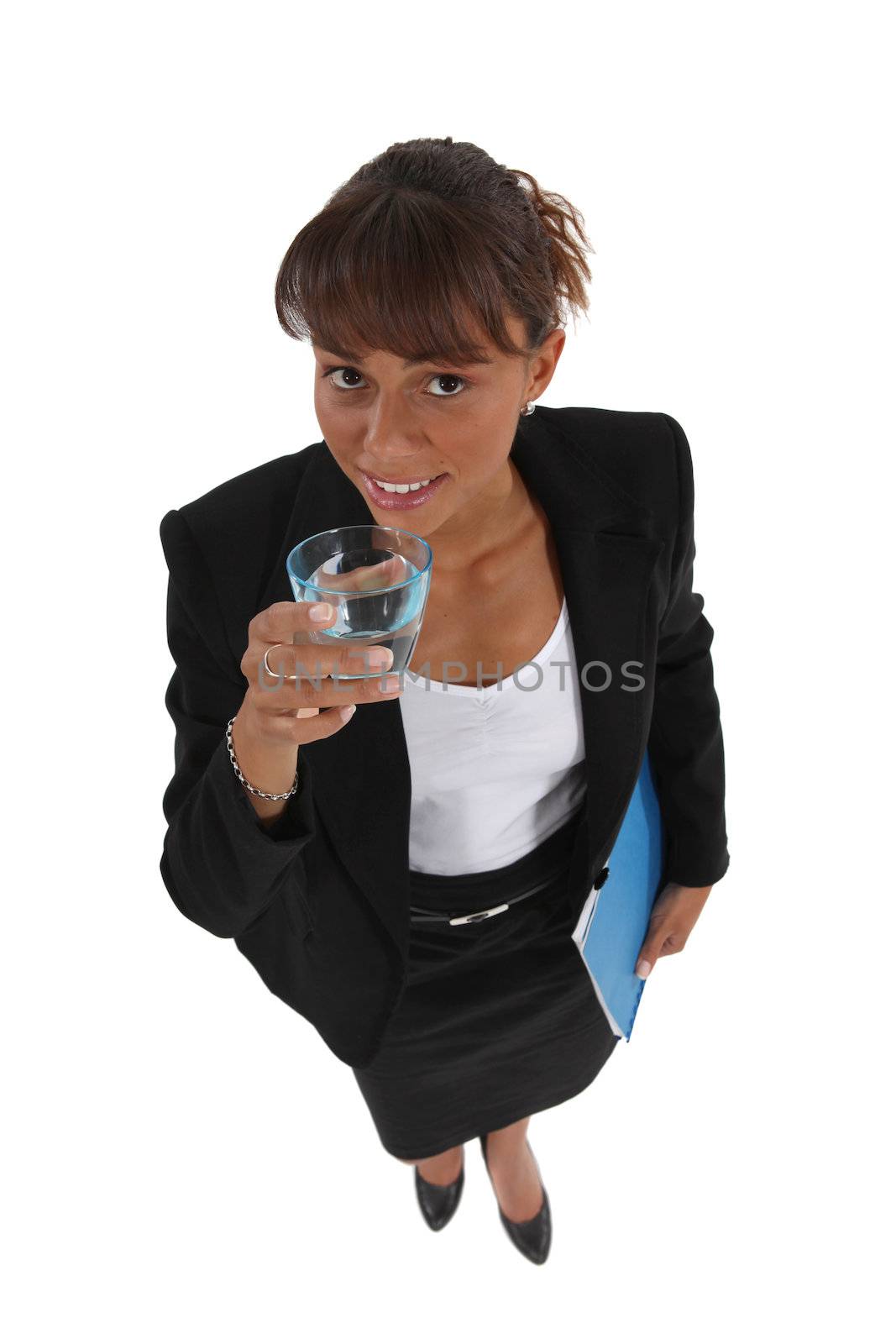 Businesswoman drinking a glass of water by phovoir