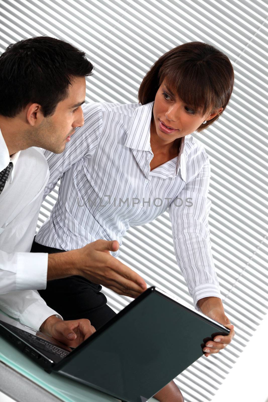 Colleagues discussing a business report