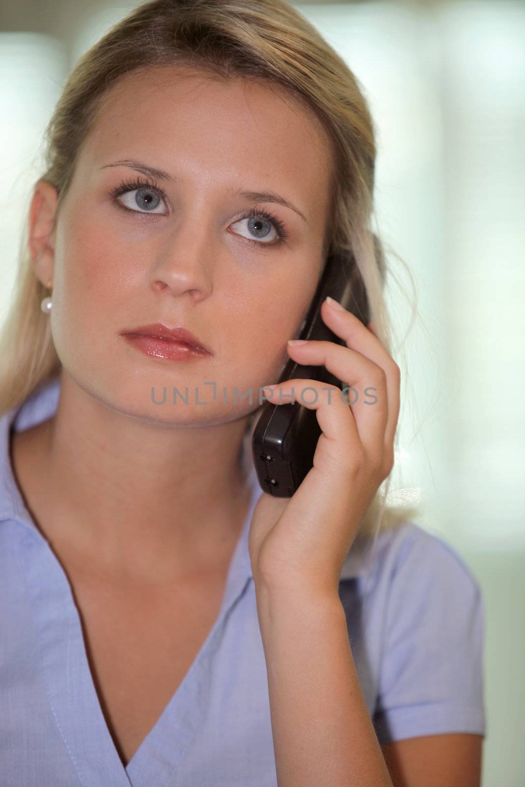 Beautiful woman talking on the phone by phovoir