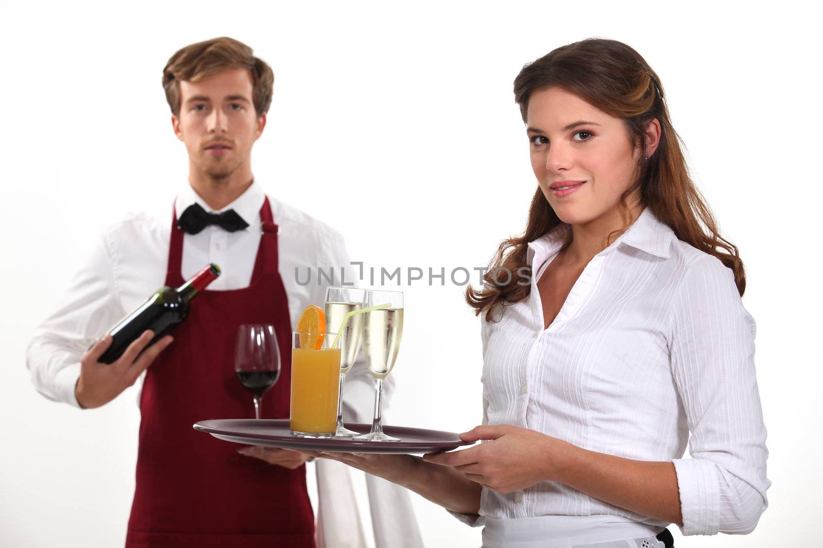 Wine waiter and waitress, studio shot by phovoir