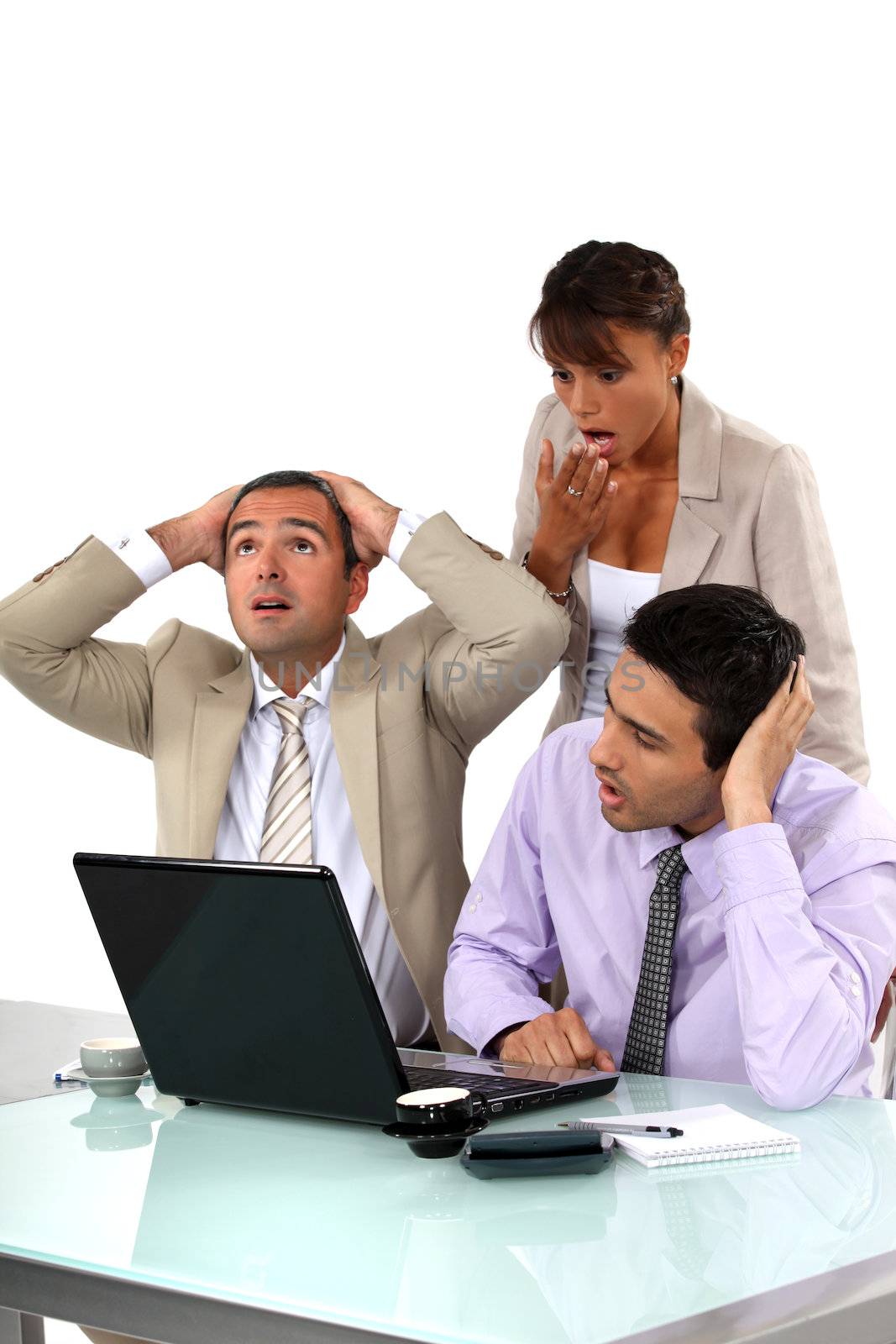 Three shocked business people looking at results by phovoir