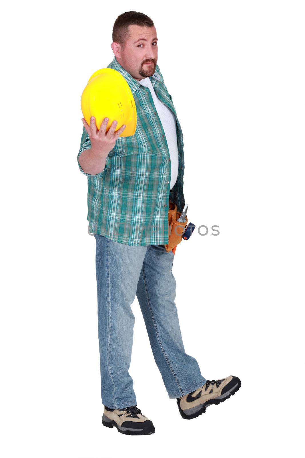 Man showing yellow helmet by phovoir