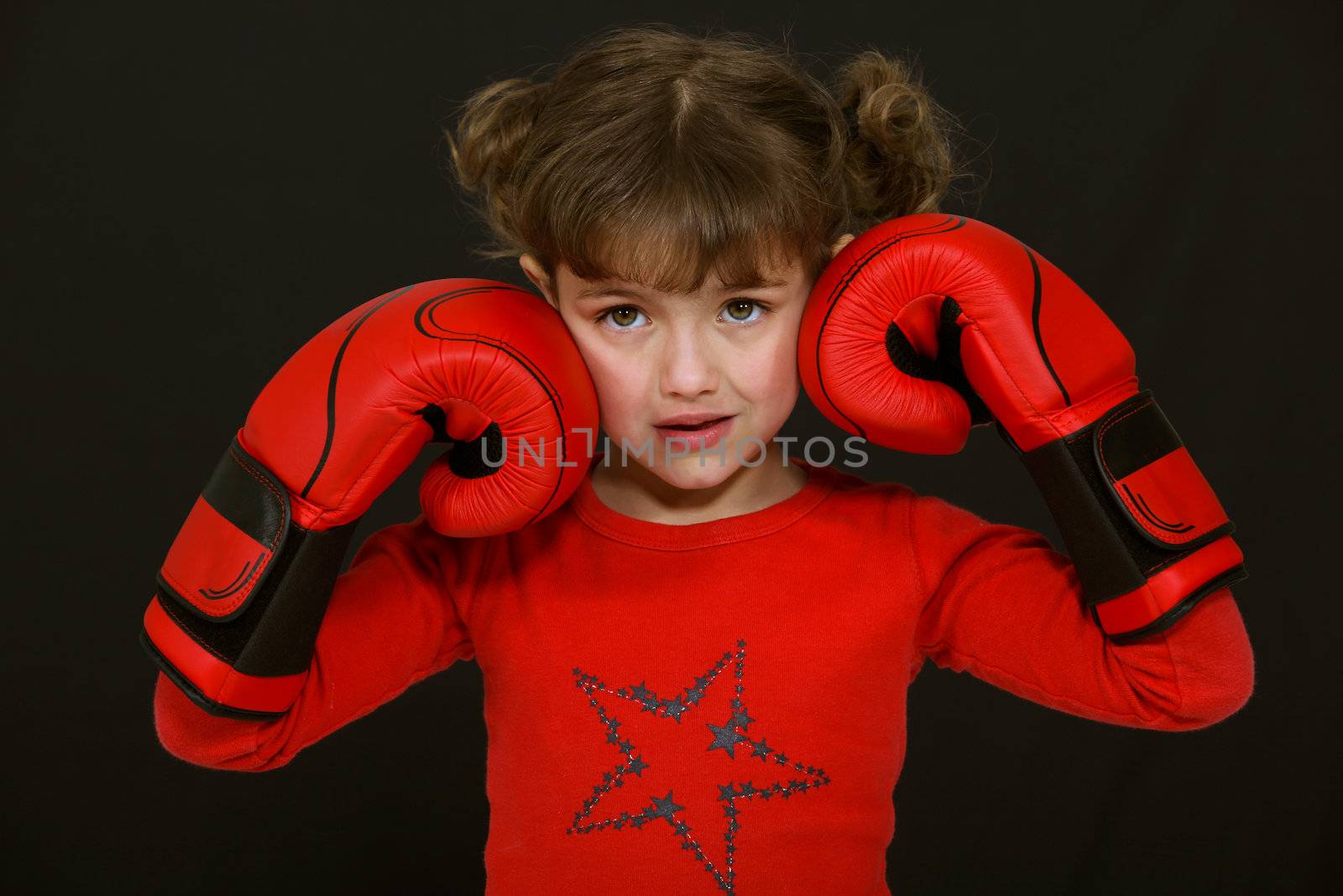 Little girl with boxing gloves by phovoir