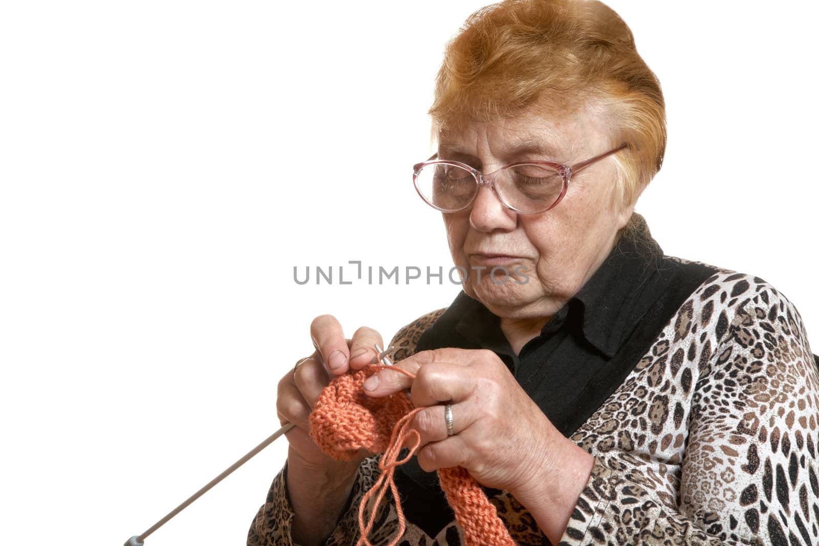 The grandmother knits spokes isolated on a white background