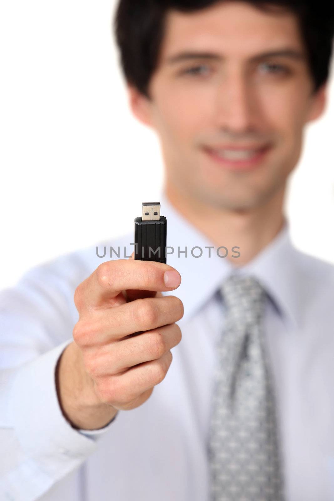 Businessman holding a usb key