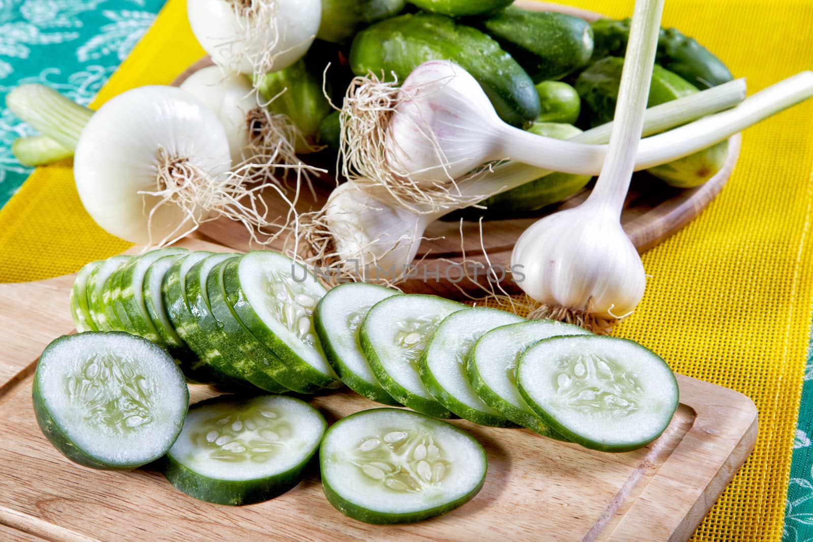 Still-life with the cut cucumbers an onions and garlic