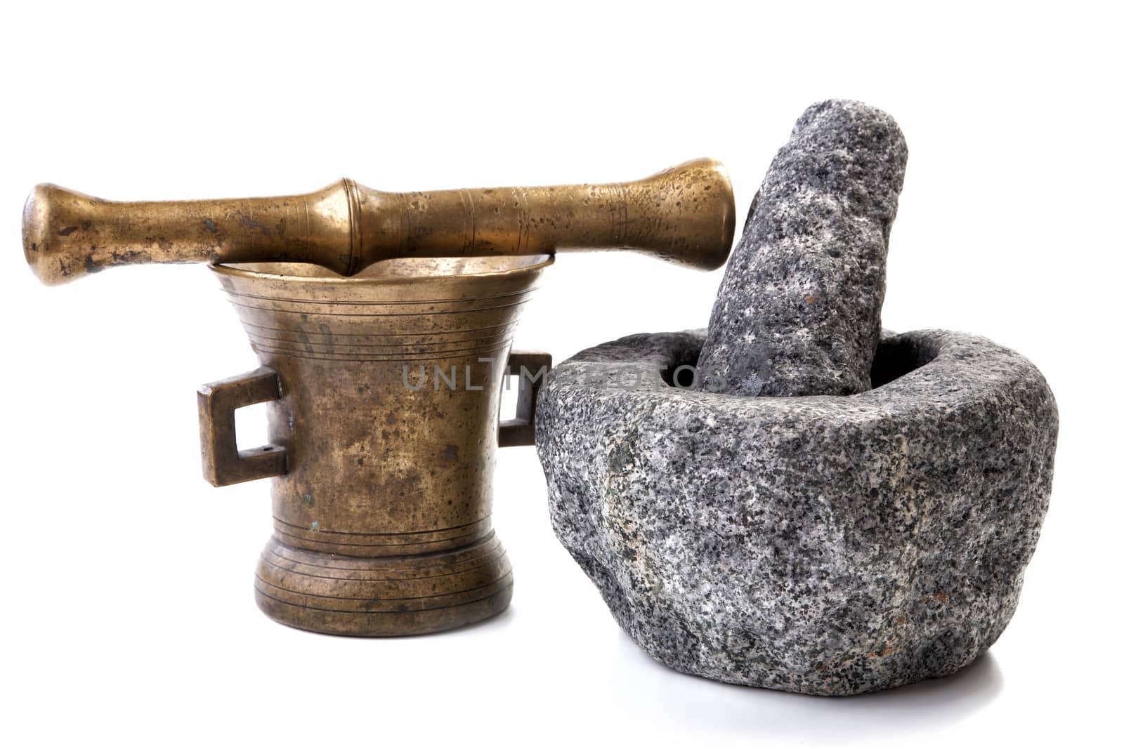 Granite and brass mortar with pestles on a white background