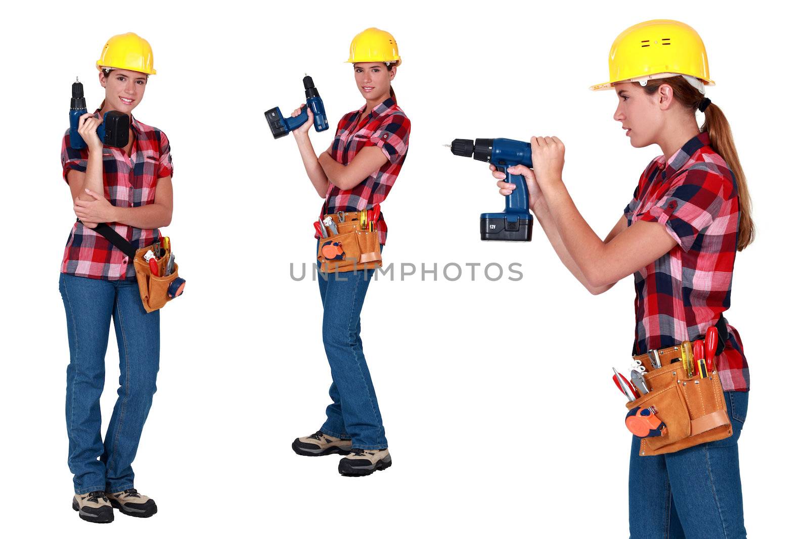 Woman using power drill by phovoir