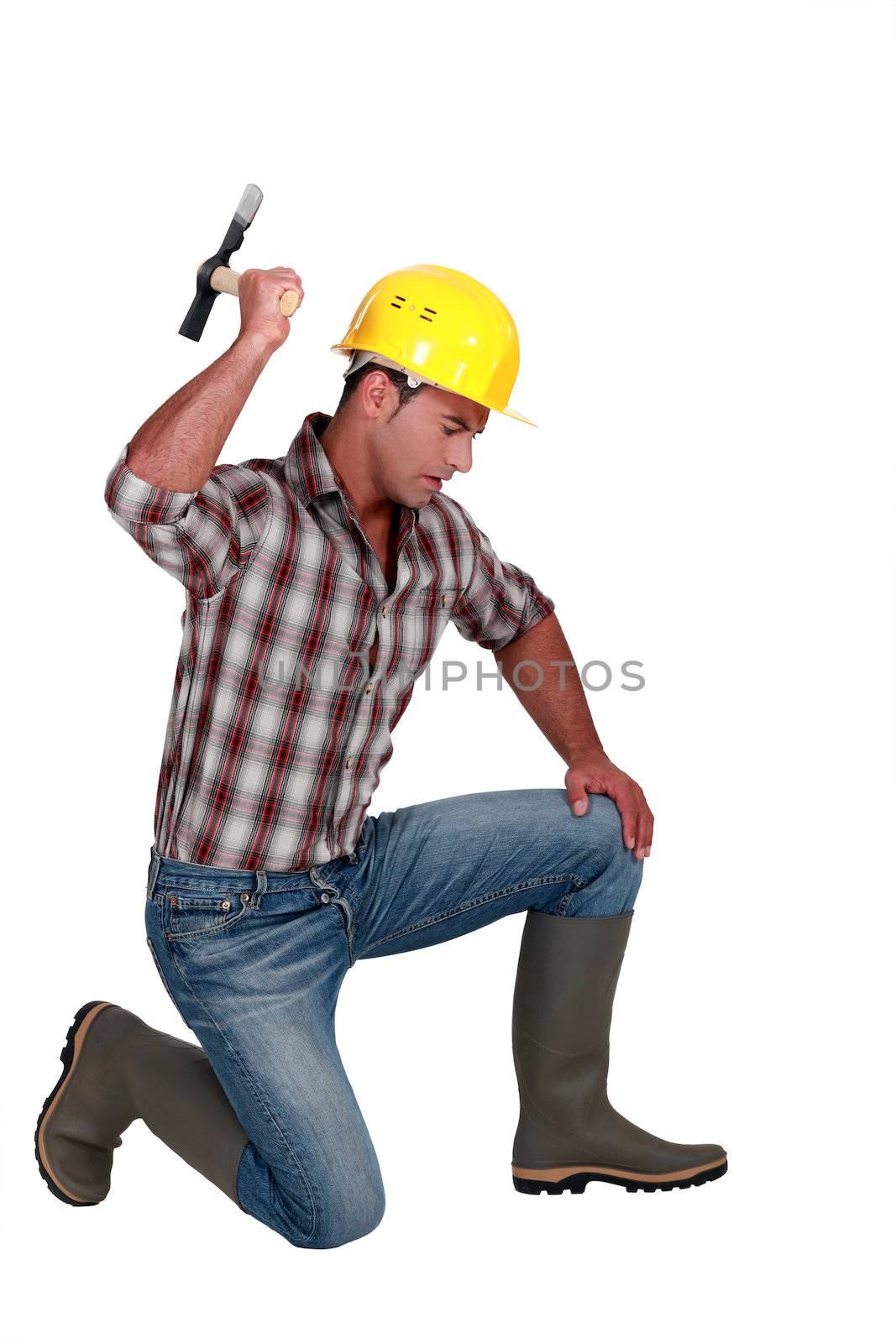 Construction worker with hammer by phovoir