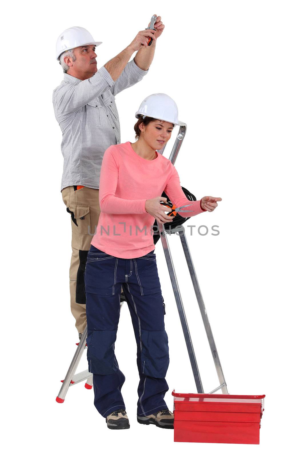 Electrician and female apprentice by phovoir