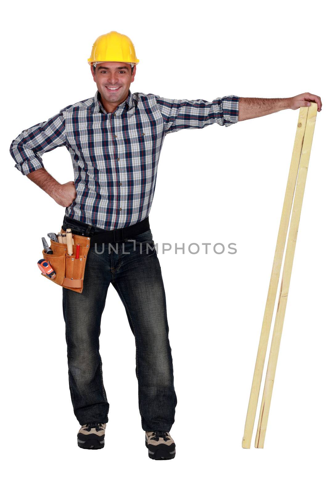 craftsman holding two wooden boards by phovoir