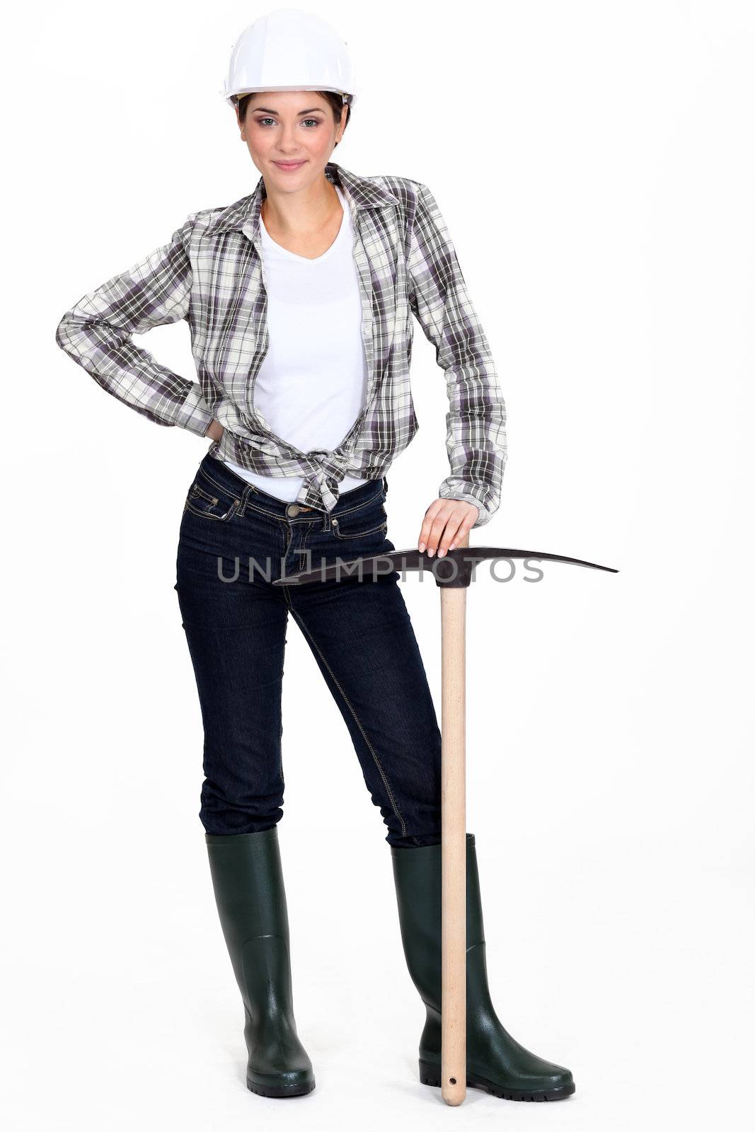 Tradeswoman holding a pickaxe by phovoir