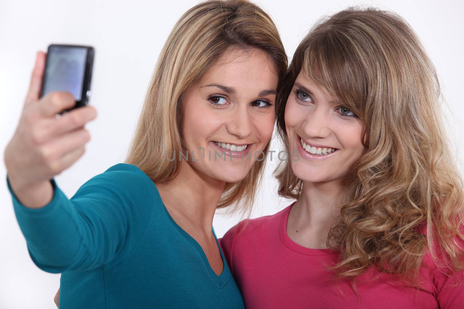 Two girls taking a picture of themselves. by phovoir