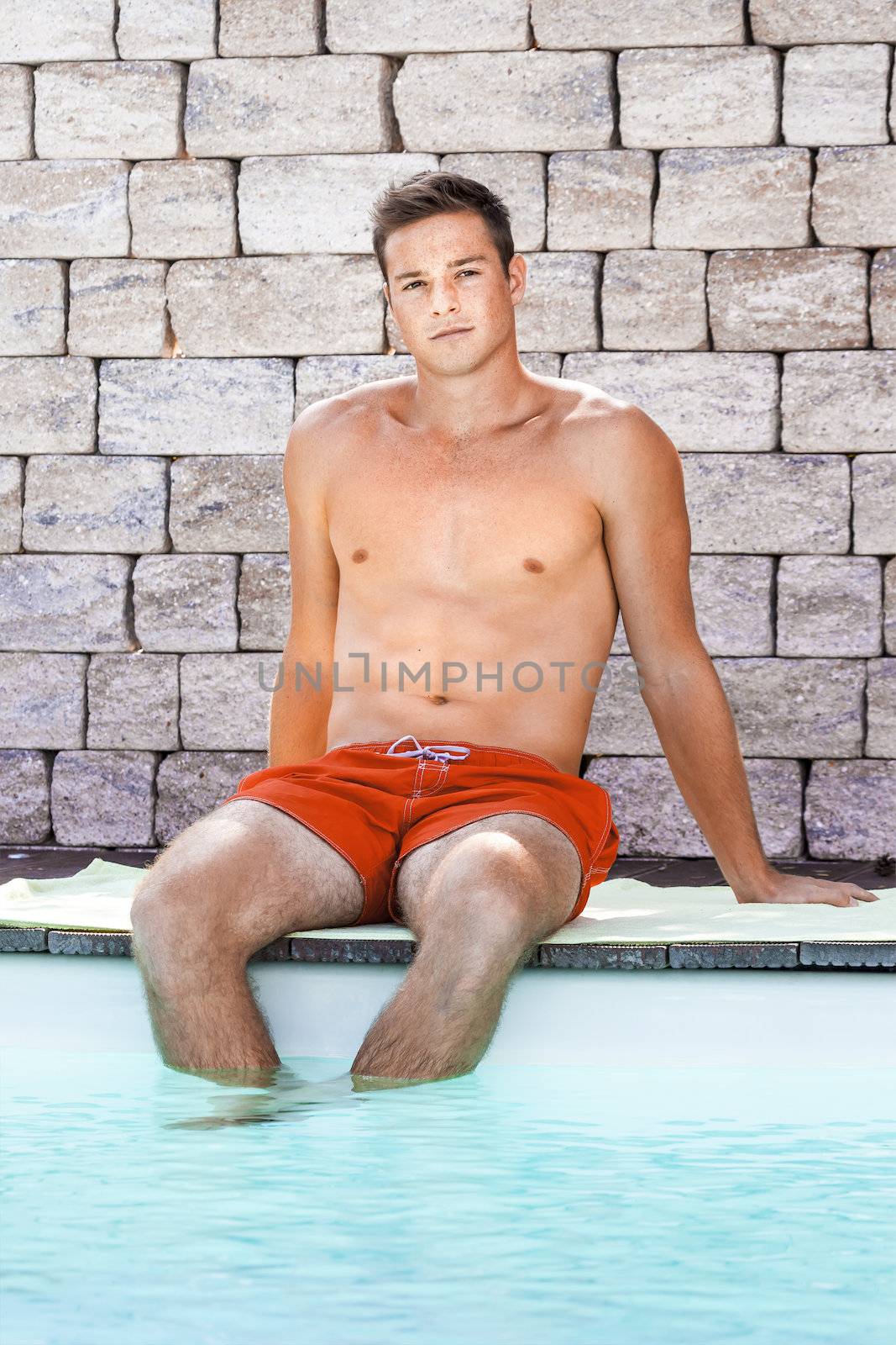 An image of a handsame man relaxing at the pool