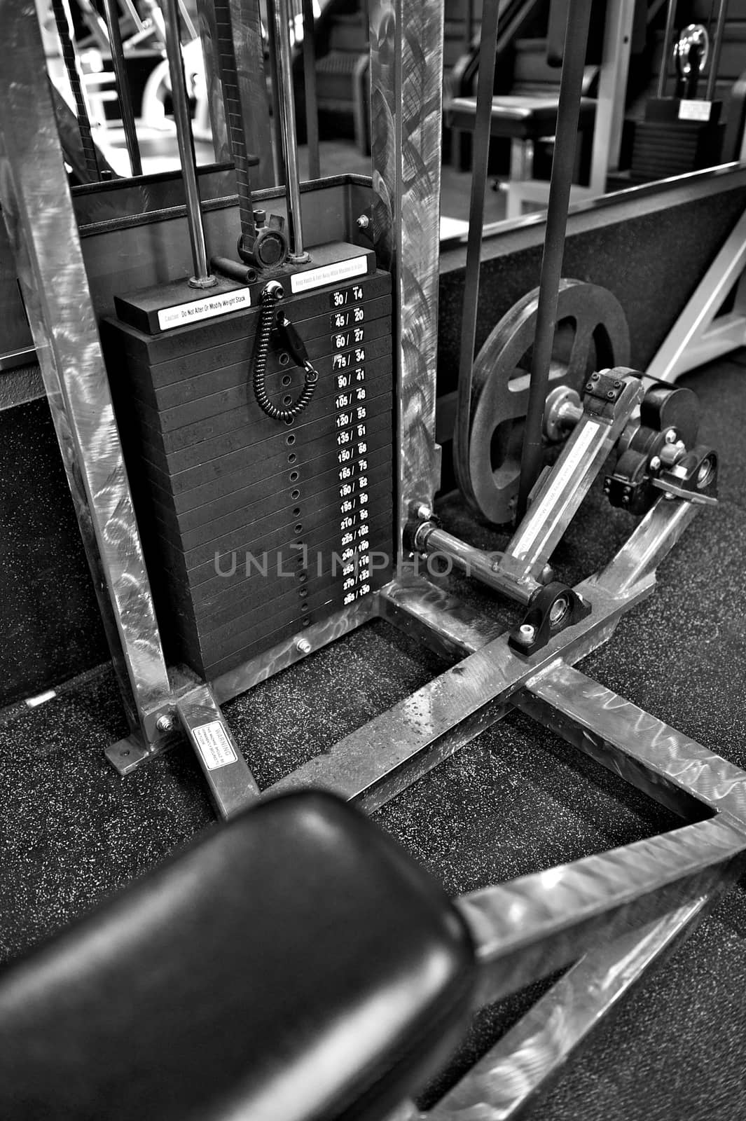 Black and white image of the weight or resistance selector on professional exercise equipment at a commercial gym
