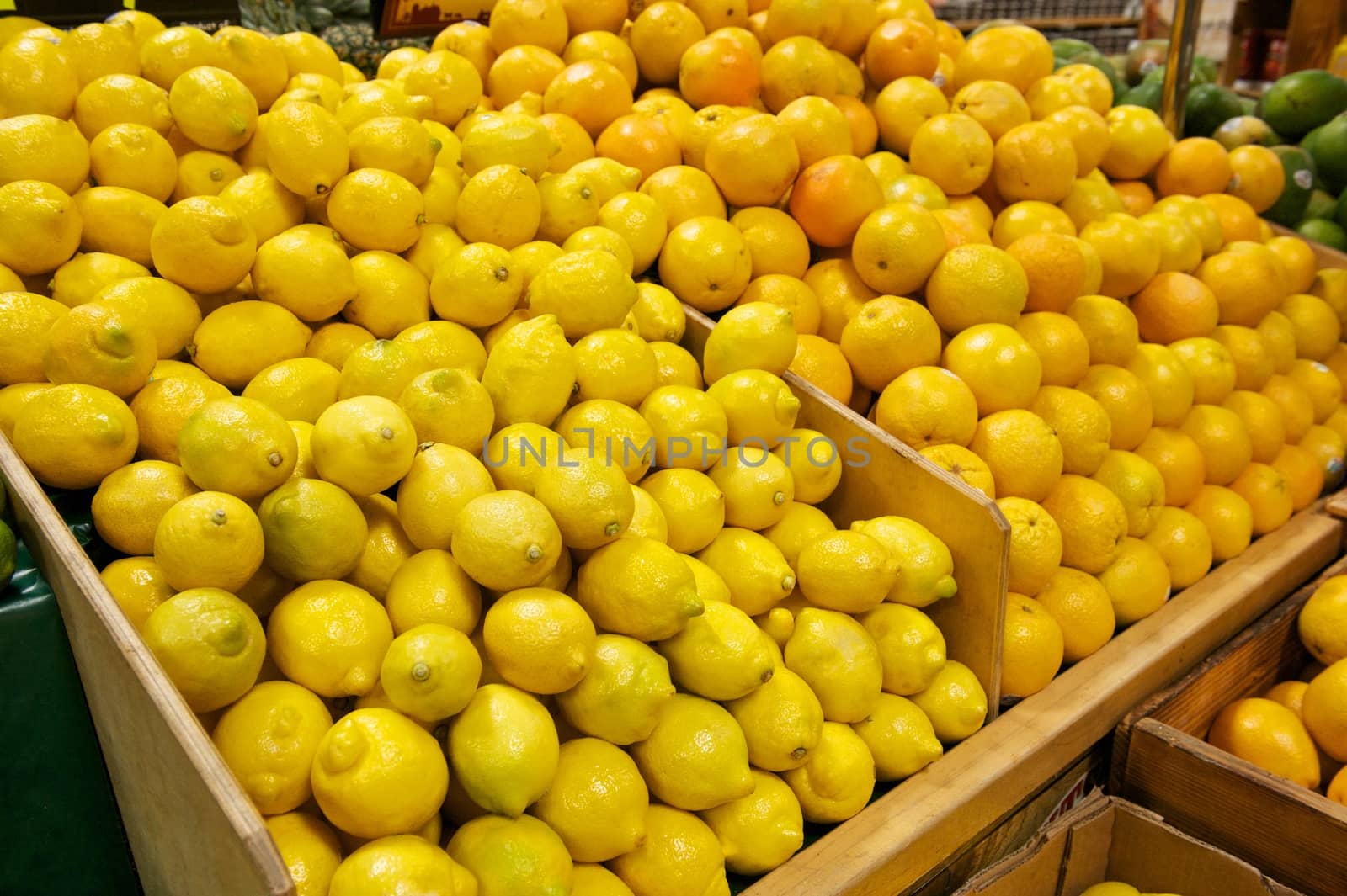 Wooden Bins Filled with Fresh Lemons and Oranges by pixelsnap
