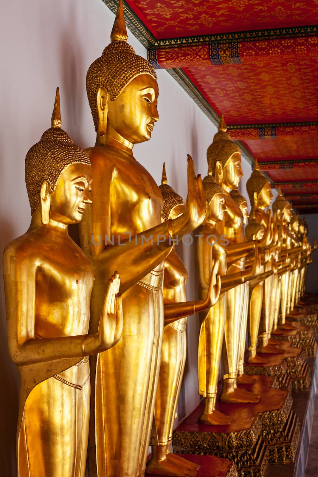 Standing golden Buddha statues close up. Wat Pho temple, Bangkok, Thailand