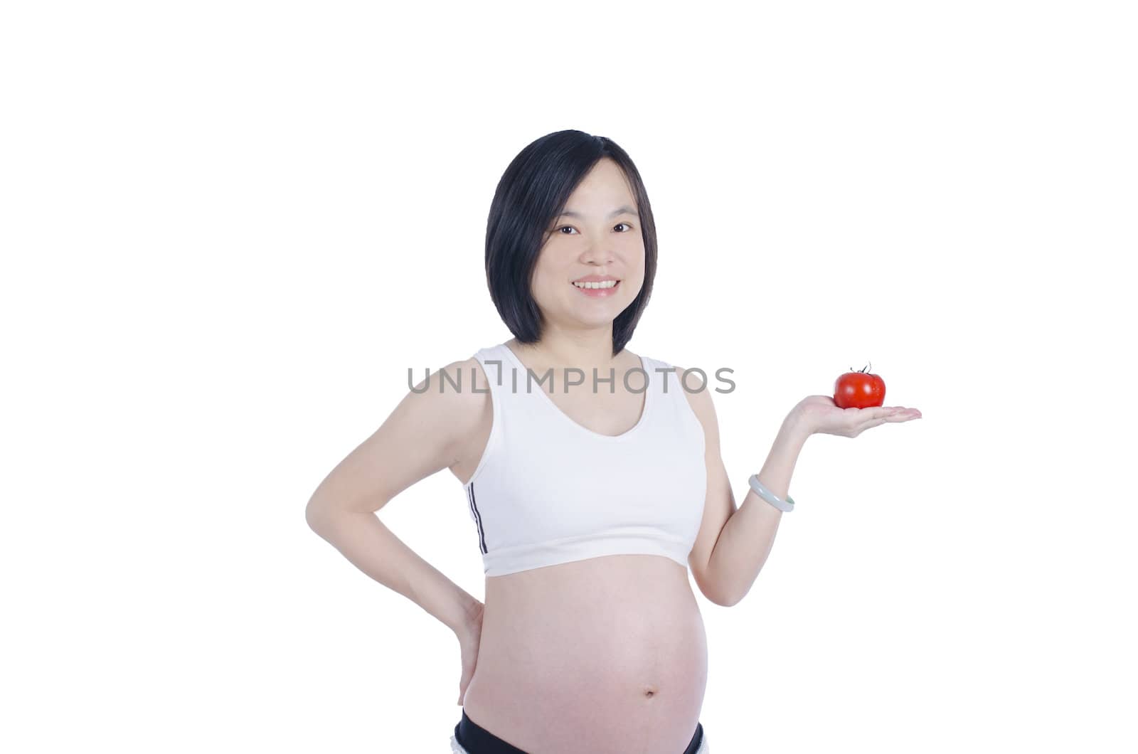 Beautiful pregnant woman with fresh tomato isolated over white background